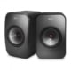 A pair of first generation KEF LSX speakers in Black on a white background